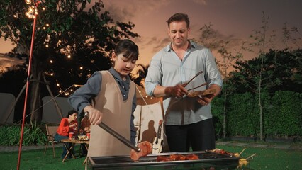 Family gather celebrate holiday, Adorable child grill food for family member. Outdoor camping...