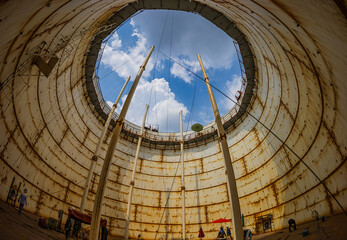 Tank oil internal overall ladder and shell plate confined space blue sky.