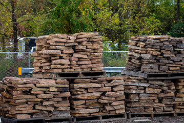 pallets with natural facing stone and cobblestones storage tiles blocks gray material storage structure