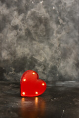 Red lighted heart on a black bacground. Copy space