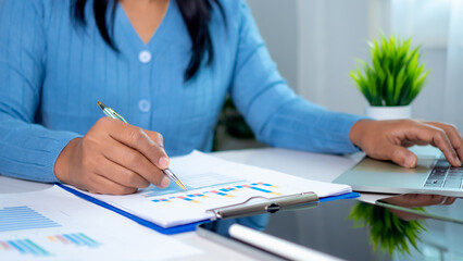 Businesswoman show paper documents to analyze business and manage corporate data, Business analytics with charts KPIs to improve organizational performance, Marketing and financial strategy.