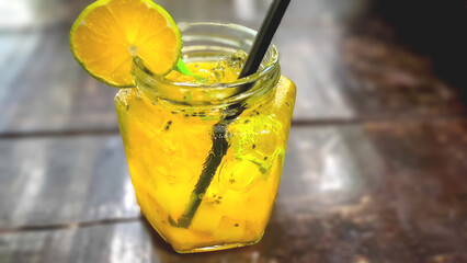 Fresh drink garnished with lemon on the cafe table