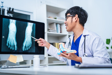 Professional Podiatrist doctor diagnose foot during medical examination of patient, doctor use foot model to explain the problem or injury of bone, structure of ankle, use x-ray to plan a surgery.