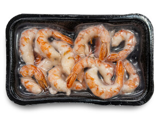 Frozen shelled shrimp in black vacuum tray isolated