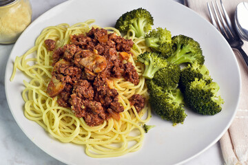 spaghetti  served with mushroom meat sauce with broccoli