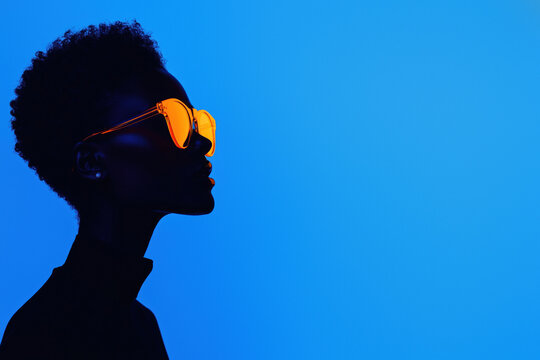 Modern silhouette with orange eyewear in deep blue