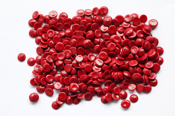 Red Plastic Pellets on White Background