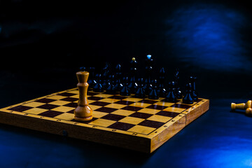 Wooden chess pieces on the chessboard. Intellectual game -chess. Chess pieces on the Board. A game of chess. One against all.