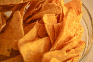 Close-up shot of a pile of corn chips in a glass bowl