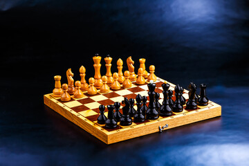 Wooden chess pieces on the chessboard. Intellectual game -chess. Chess pieces on the Board. A game of chess.