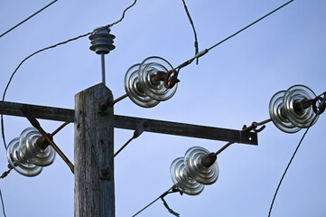 Electrical pole with glass insulators. Distribution transformers. Power transformer. Old power and communication pole.