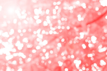 Red bokeh background creates a soft light effect, with abstract glitter adding a glamorous touch, blending white and black tones into the festive Christmas design.