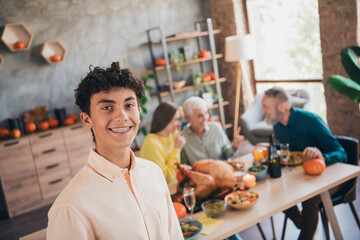 Photo of young teen grandson smile cheerful family meeting eating thanksgiving holiday dinner good mood having fun home indoors