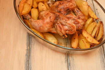 baked potatoes with roasted chicken photo from above, cinnamon crispy crust of roasted chicken and potatoes, baked dinner 