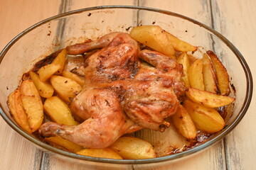 baked chicken with potatoes photo from above, cinnamon crispy crust of roasted chicken and potatoes, baked dinner