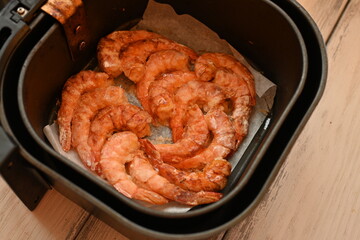 baked shrimps without shells in aero grill, tasty healthy food concept, baked seafood in breading, European cuisine, fried cooked shrimp tails fried in clary close-up 