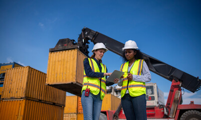 Engineer or dockworker working in the construction container dock yard checking and inspection...