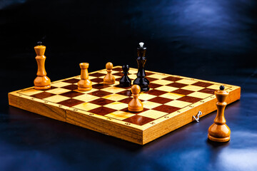Wooden chess pieces on the chessboard. Intellectual game -chess. Chess pieces on the Board. A game of chess.