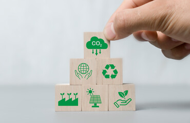 Hand holding CO2 reducing ,Recycle ,Green factory icon for decrease CO2 , carbon footprint and carbon credit to limit global warming from climate change, Bio Circular Green Economy concept..