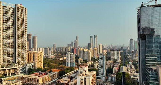 Golden Horizons: Captivating Evening Aerial of Mumbai's Skyline at Sunset, Over Lower Parel, Mahalaxmi, and Currey Road. Silhouette shot of Mumbai's skyline in the evening.
