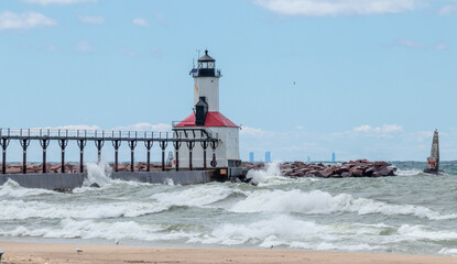 Lake Michigan waves crashing on to the Michigan City Lighthouse in Michigan City, Indiana USA on a summer day 