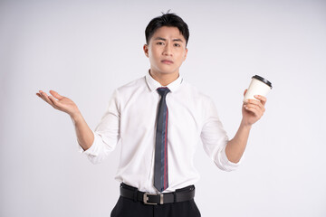 Portrait of young Asian business man drinking coffee and posing on white background