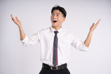 Portrait of young Asian business man posing on white background