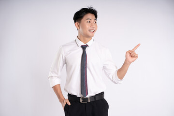 Portrait of young Asian business man posing on white background