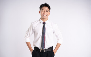 Fototapeta premium Portrait of young Asian business man posing on white background