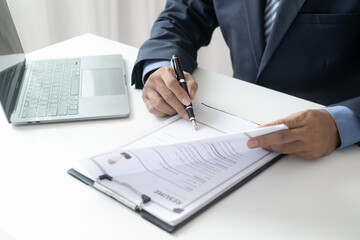 Executive CEO businessman checking job applicant documents resumes, interviews, and signing to approve the contract in the office room