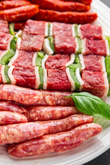 meat sausage assorted juicy pork, beef fresh gourmet food background on the table rustick food top view copy space