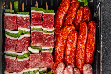 meat sausage assorted juicy pork, beef fresh gourmet food background on the table rustick food top view copy space