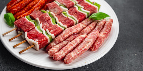 meat sausage assorted juicy pork, beef fresh gourmet food background on the table rustick food top view copy space