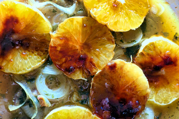 Orange slices coated in Demerara sugar after being cooked in the oven as an ingredient in a Californian Pork dish
