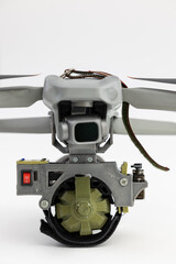 Naklejka premium Engineering development for war, army drone with mechanism for dropping grenades on white isolated background. Concept military UAVs using in weapon