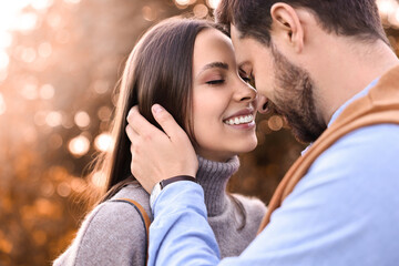 Fototapeta premium Beautiful couple spending time together outdoors on autumn day