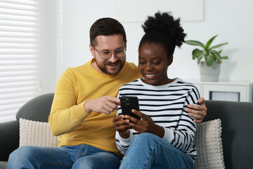 International relationships. Lovely couple spending time together at home