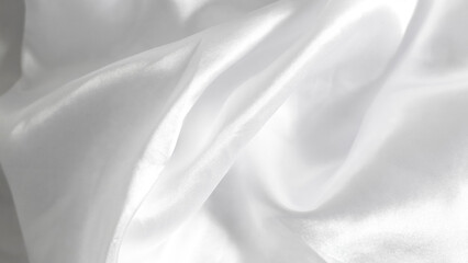 Smooth white silk bedsheets, soft and luxurious fabric, elegant blanket background.