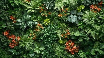 Lush Green Wall with Orange Flowers and Various Leaf Shapes