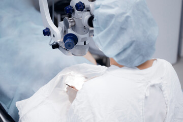 Lasik treatment, laser vision correction. Doctor performs operation replacement of lens in eye and...