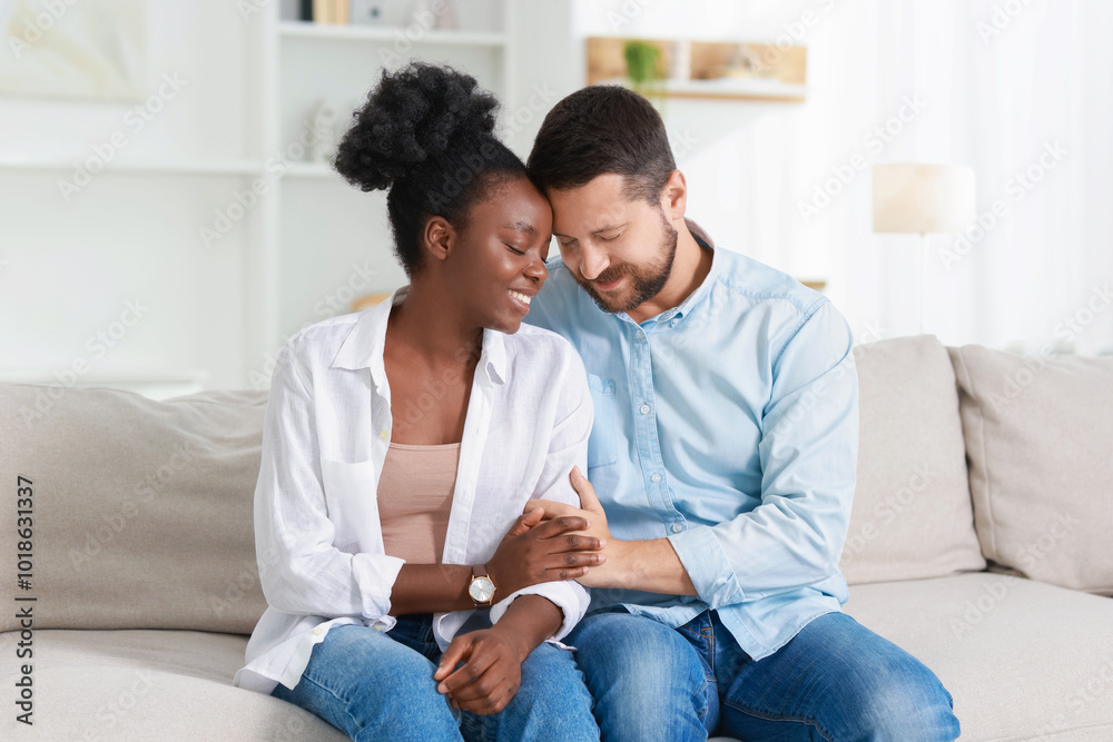 Poster International relationships. Portrait of lovely couple on sofa at home