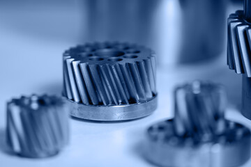 Macro photo metal engine gear wheels. Industrial background blue toning, concept fix service