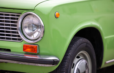 Detail of classic style searchlight  of green Lada car, Pécs, Hungary - 23. october 2022.