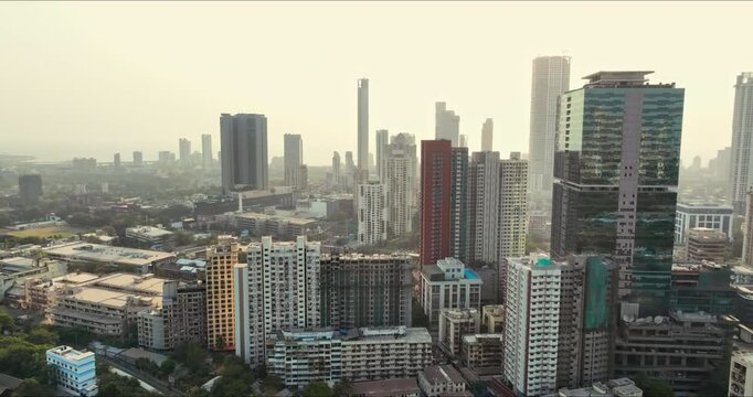 Golden Horizons: Captivating Evening Aerial of Mumbai's Skyline at Sunset, Over Lower Parel, Mahalaxmi, and Currey Road. Highrise buildings. High-rise residential buildings in Indian city.
