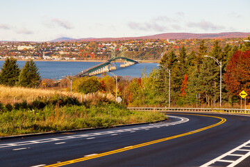 Road descending in the direction of the Island of Orleans bridge over the St. Lawrence river seen...