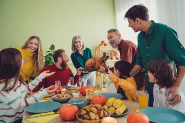 Photo of charming beautiful big family celebrating thanksgiving day occasion sitting eating turkey indoors room home