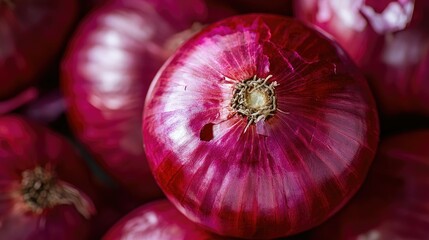 A close-up shot of a single raw onion, with its skin half-peeled, highlighting the contrast between the outer layer and the crisp interior.