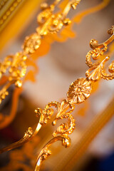 Fototapeta premium Exquisite gold ornate detailing on luxurious antique furniture
