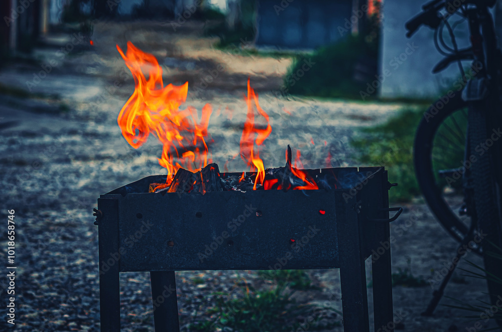 Wall mural hearth in metal brazier. lighting fire for cooking barbecue.