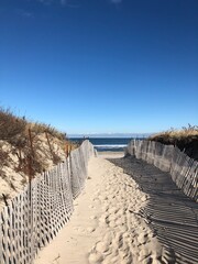 New England Beach Pathway Leading to Ocean with Blue Sky and Sand Dunes